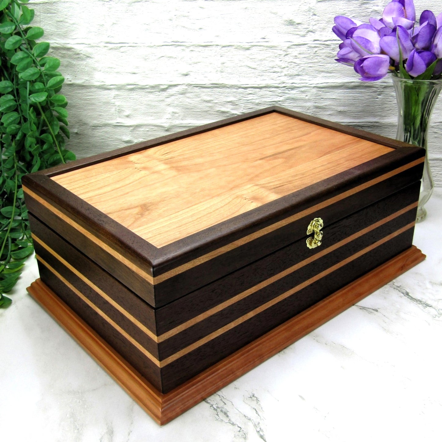 Thumbnail of handmade keepsake box crafted from Peruvian walnut, cherry, cherry veneer, and a pear base by A Finer Cut Woodworking.
