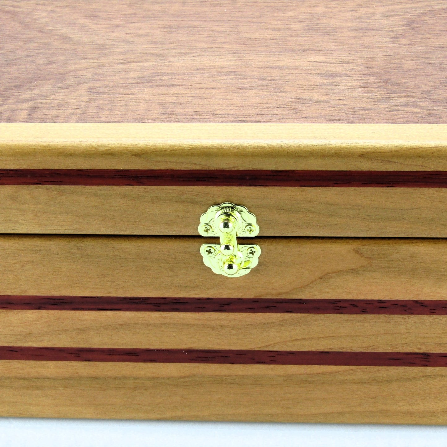 Inlays on handmade memory box crafted from cherry and mahogany wood with padauk inlays by A Finer Cut Wood.