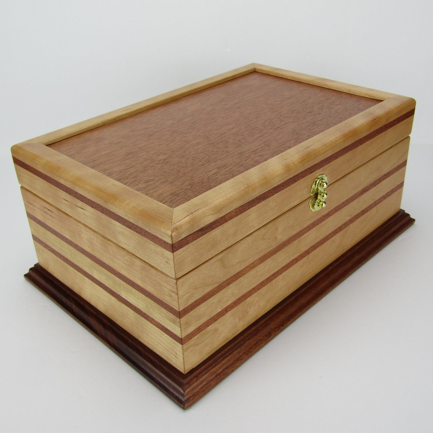 Front corner view of handmade wood jewelry box crafted from cherry with Brazilian cherry inlays by A Finer Cut Woodwork.