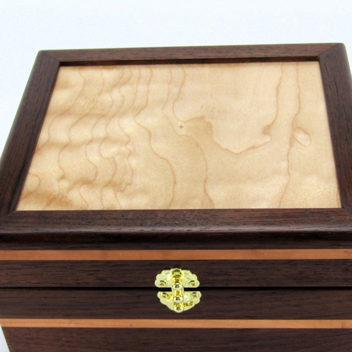 Lid details on keepsake memory box handmade from Peruvian walnut and pear wood by A Finer Cut Woodwork.