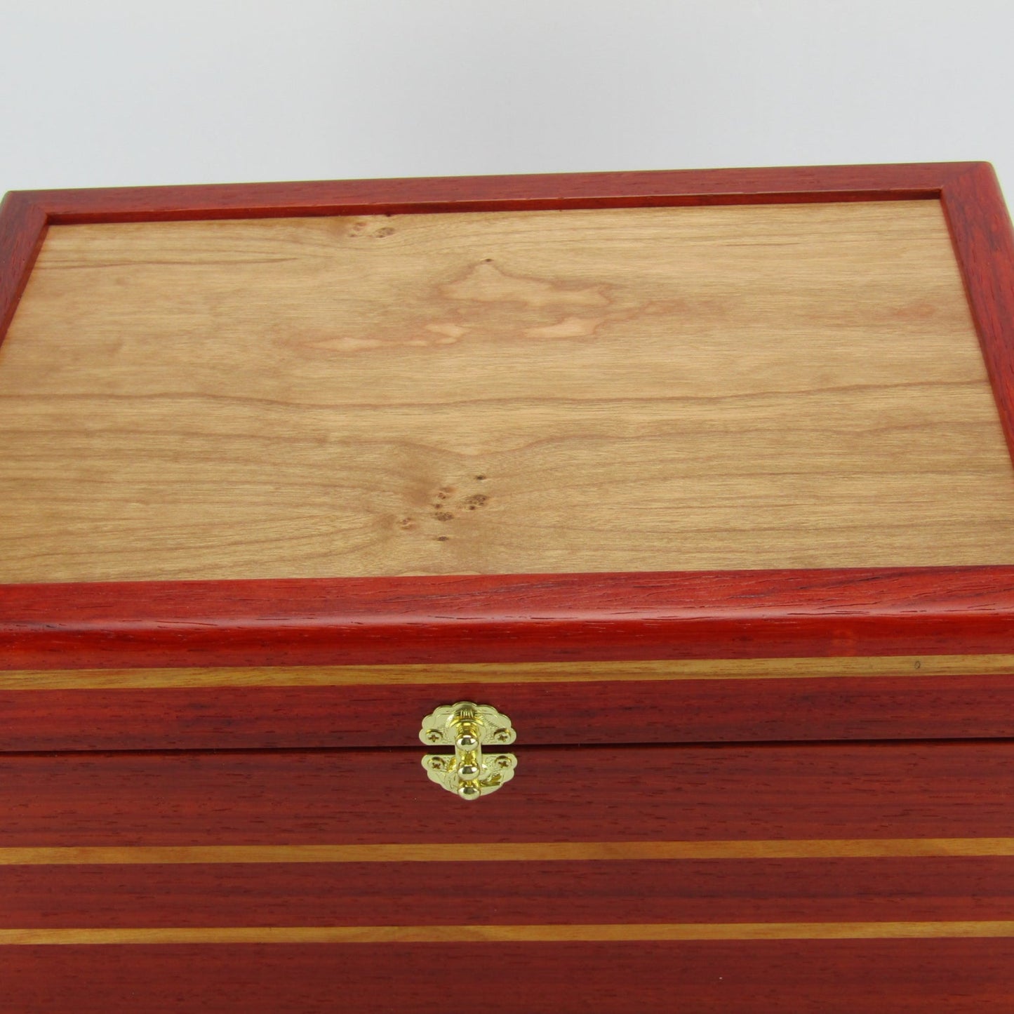 Top view of large memory box handmade from padauk and canary wood by A Finer Cut Woodworking.