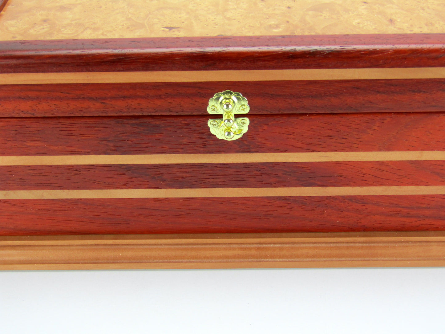 Inlays on unique memorial keepsake box handmade from red padauk and pear wood by A Finer Cut Woodworking.