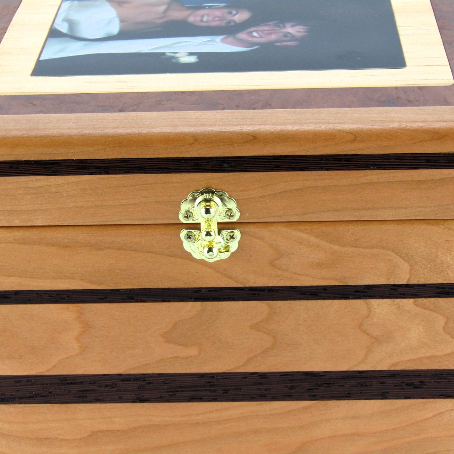 Inlays on memory box handcrafted from cherry, wenge, and mahogany burl veneer by A Finer Cut Woodworking.