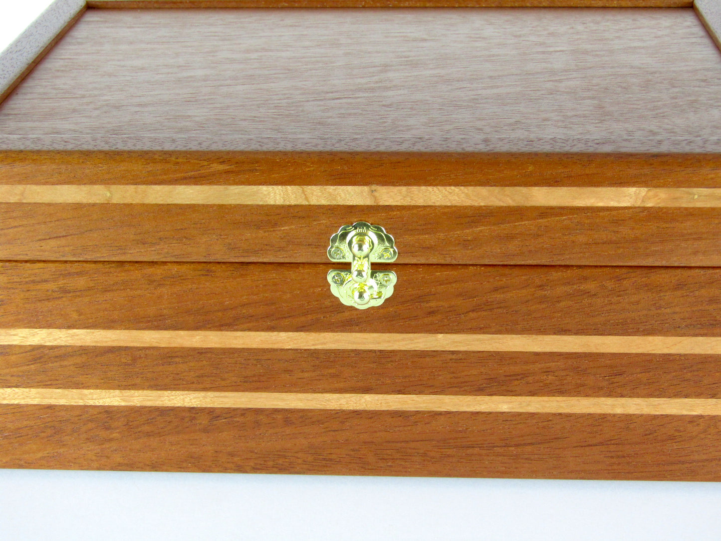 Inlays on valet box for men handcrafted from mahogany with cherry wood inlays by A Finer Cut Woodworking.