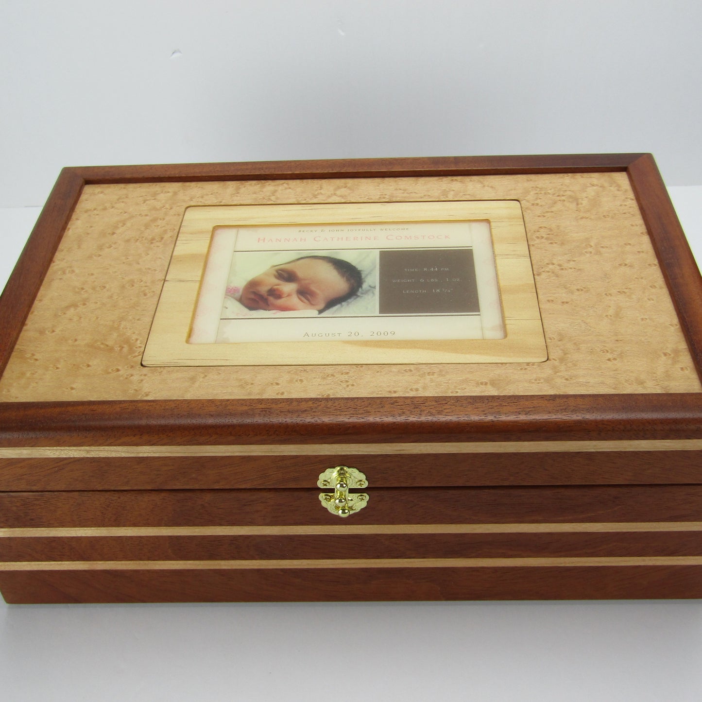 Top view of children's memory box with photo lid handmade from mahogany, cherry, and maple burl veneer by A Finer Cut Woodworking. 