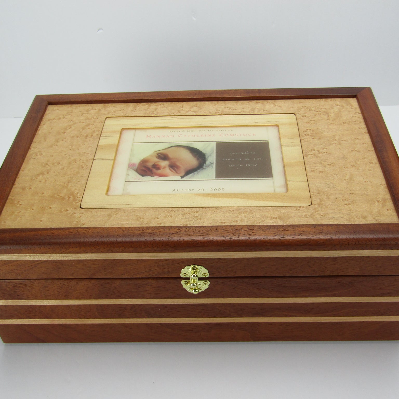 Top view of children's memory box with photo lid handmade from mahogany, cherry, and maple burl veneer by A Finer Cut Woodworking. 