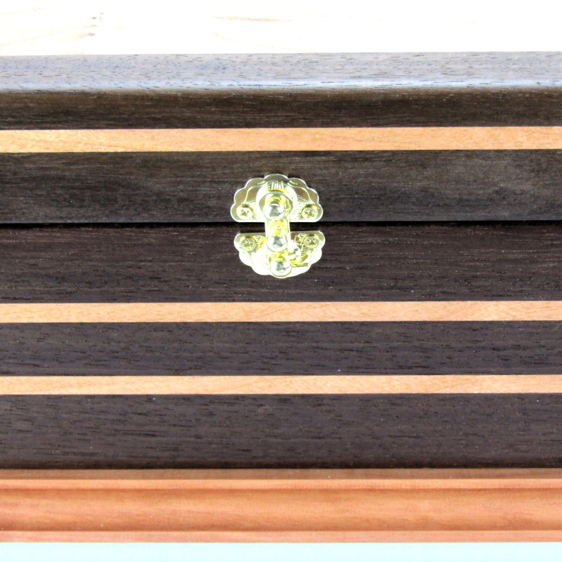 Inlays on handmade keepsake box crafted from Peruvian walnut, cherry, cherry veneer, and a pear base by A Finer Cut Woodworking.