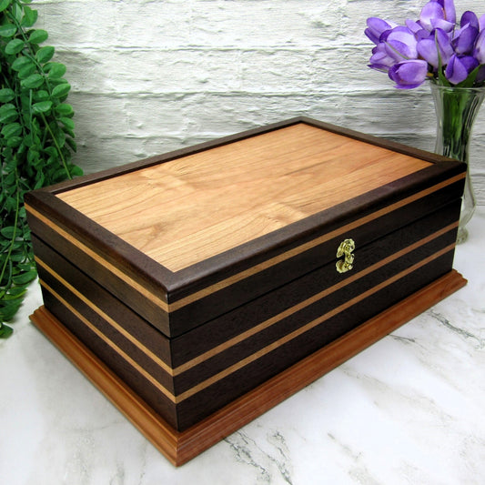 Thumbnail of handmade keepsake box crafted from Peruvian walnut, cherry, cherry veneer, and a pear base by A Finer Cut Woodworking.