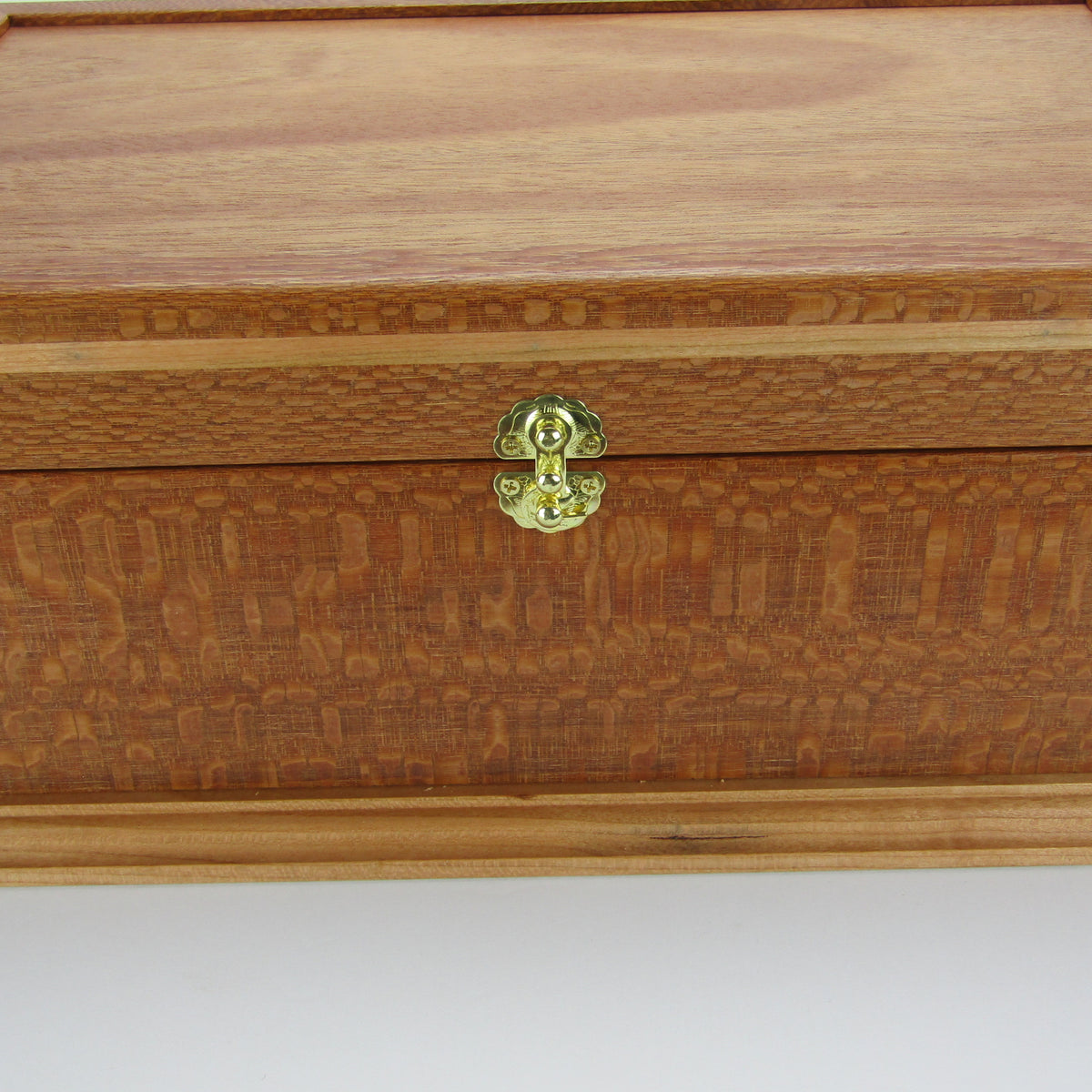 Front view of handmade keepsake box crafted from leopardwood, cherry, and mahogany veneer by A Finer Cut Woodworking.
