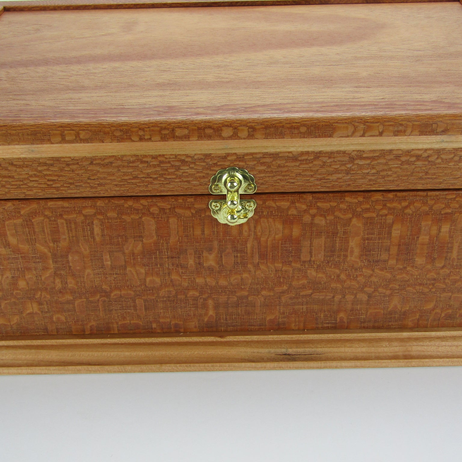 Front view of handmade keepsake box crafted from leopardwood, cherry, and mahogany veneer by A Finer Cut Woodworking.