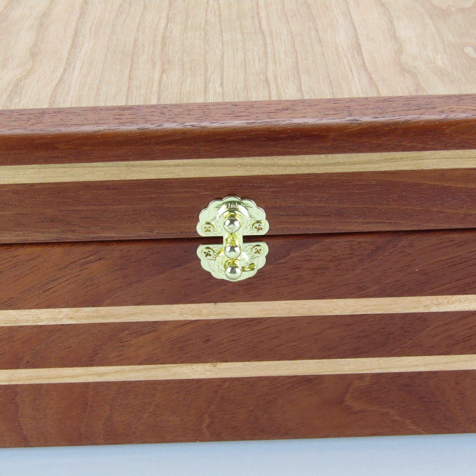 >Inlays on handmade keepsake box crafted from mahogany, cherry, and cherry veneer by A Finer Cut Woodworking.