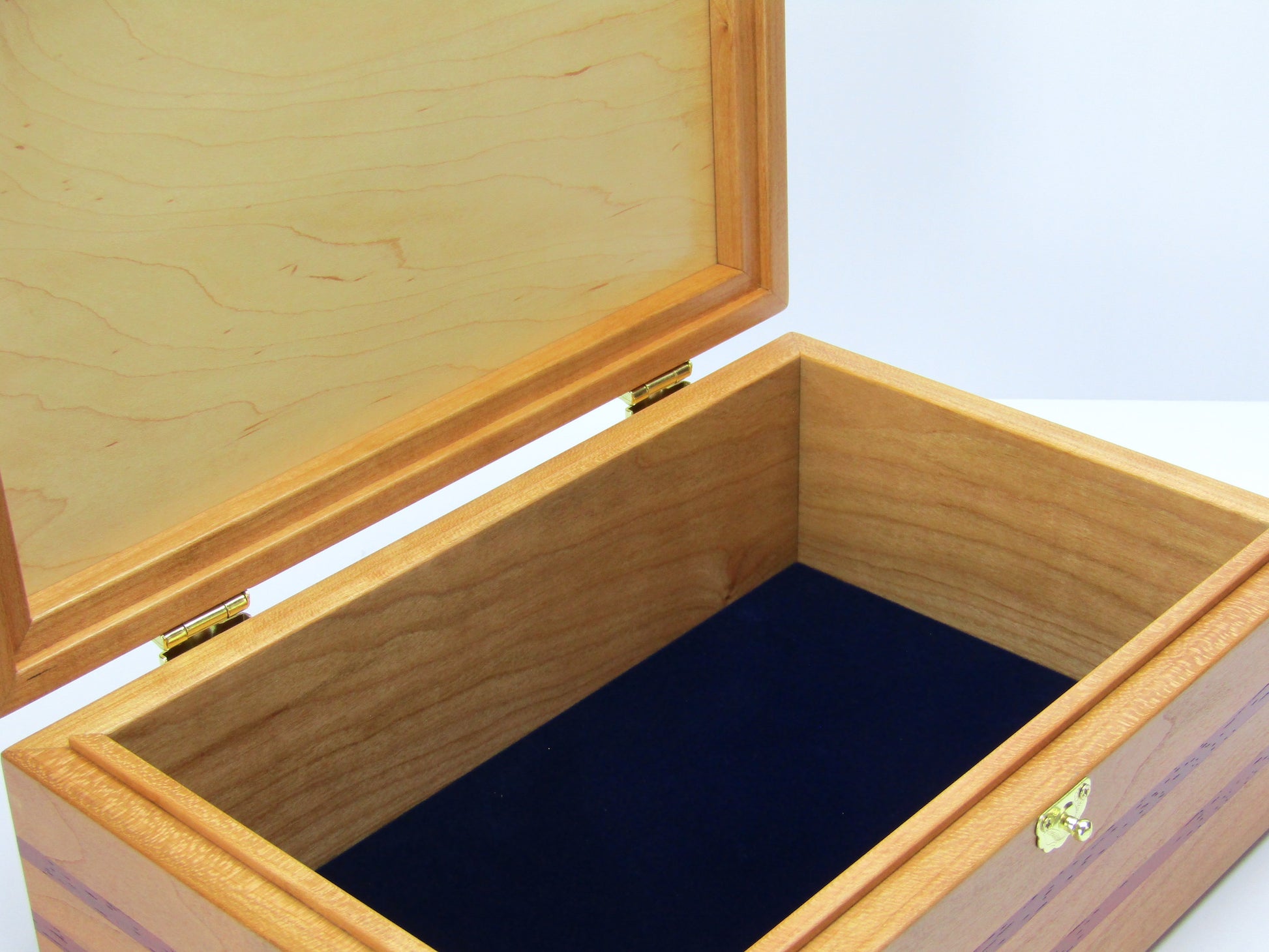 Interior view of handmade memory box crafted from cherry and mahogany wood with padauk inlays by A Finer Cut Wood.