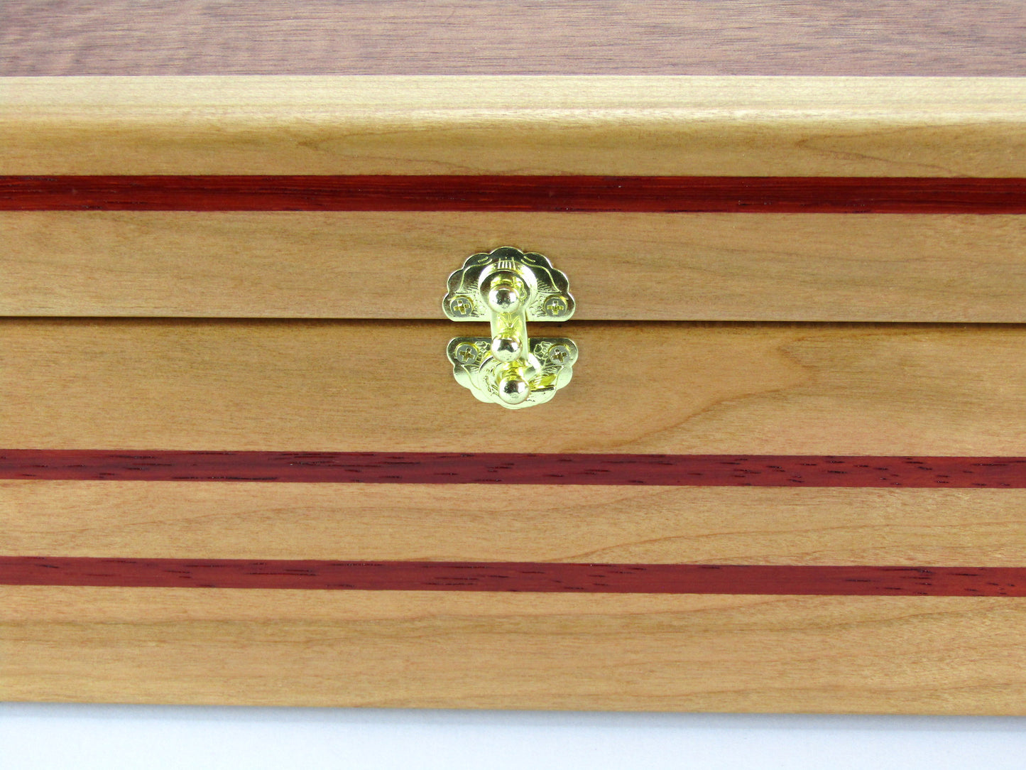 Inlays on handmade memory box crafted from cherry and mahogany wood with padauk inlays by A Finer Cut Wood.