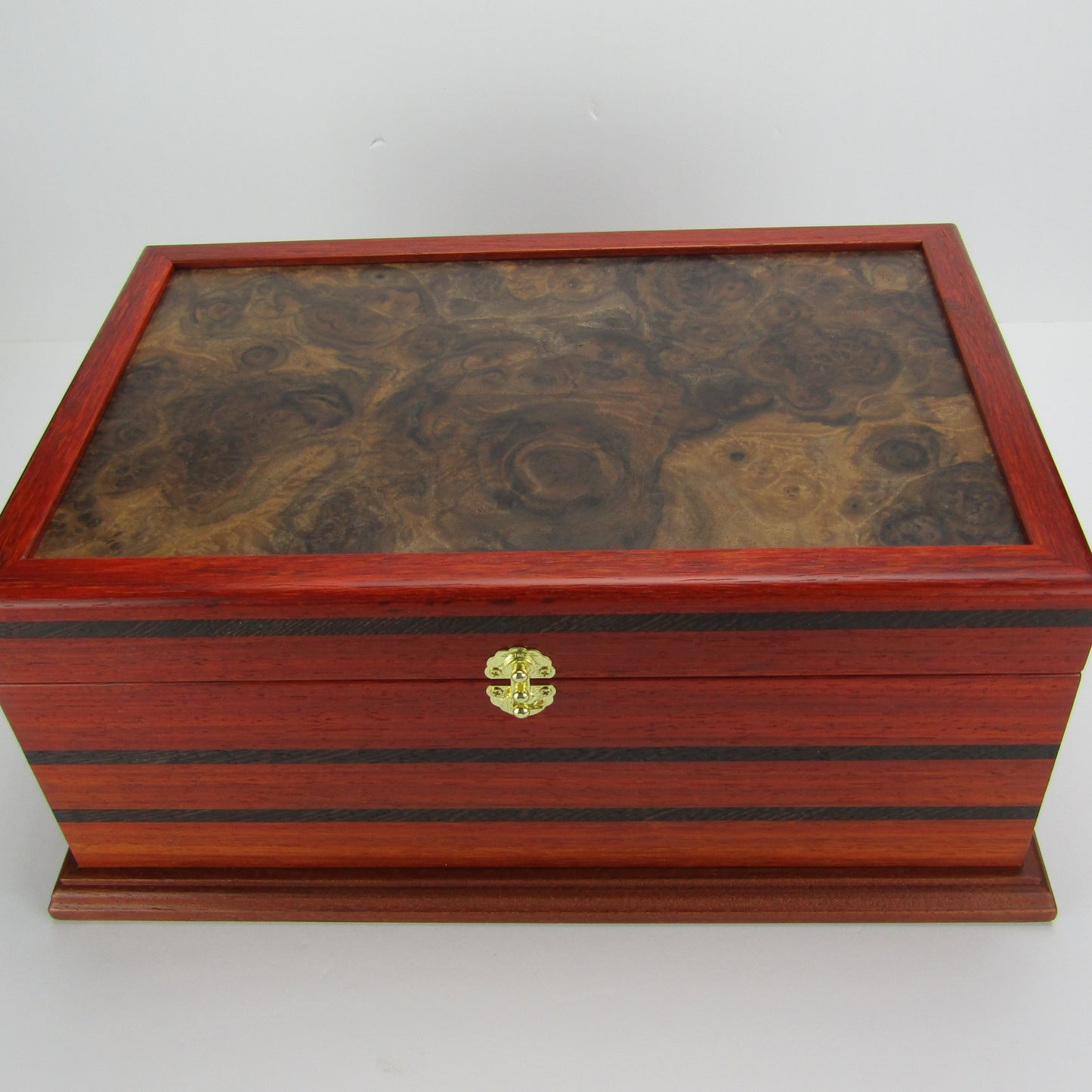Top view of handmade wooden box crafted from padauk, wenge, Brazilian cherry, and walnut burl veneer by A Finer Cut Woodworking.