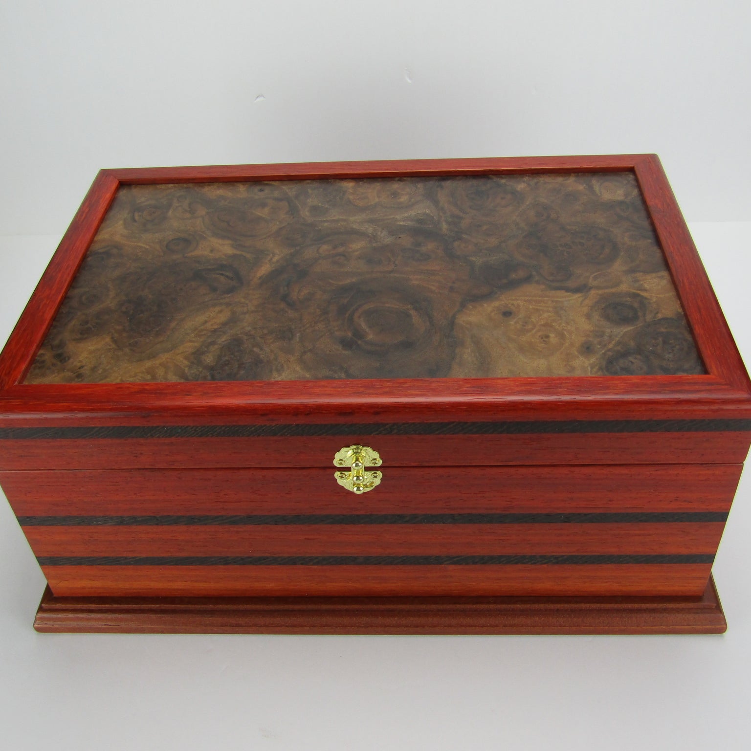 Top view of handmade wooden box crafted from padauk, wenge, Brazilian cherry, and walnut burl veneer by A Finer Cut Woodworking.