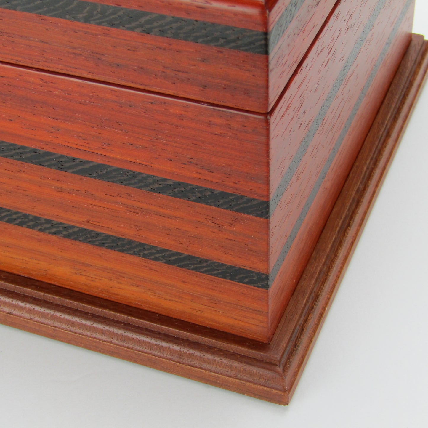 Inlays on handmade wooden box crafted from padauk, wenge, Brazilian cherry, and walnut burl veneer by A Finer Cut Woodworking.
