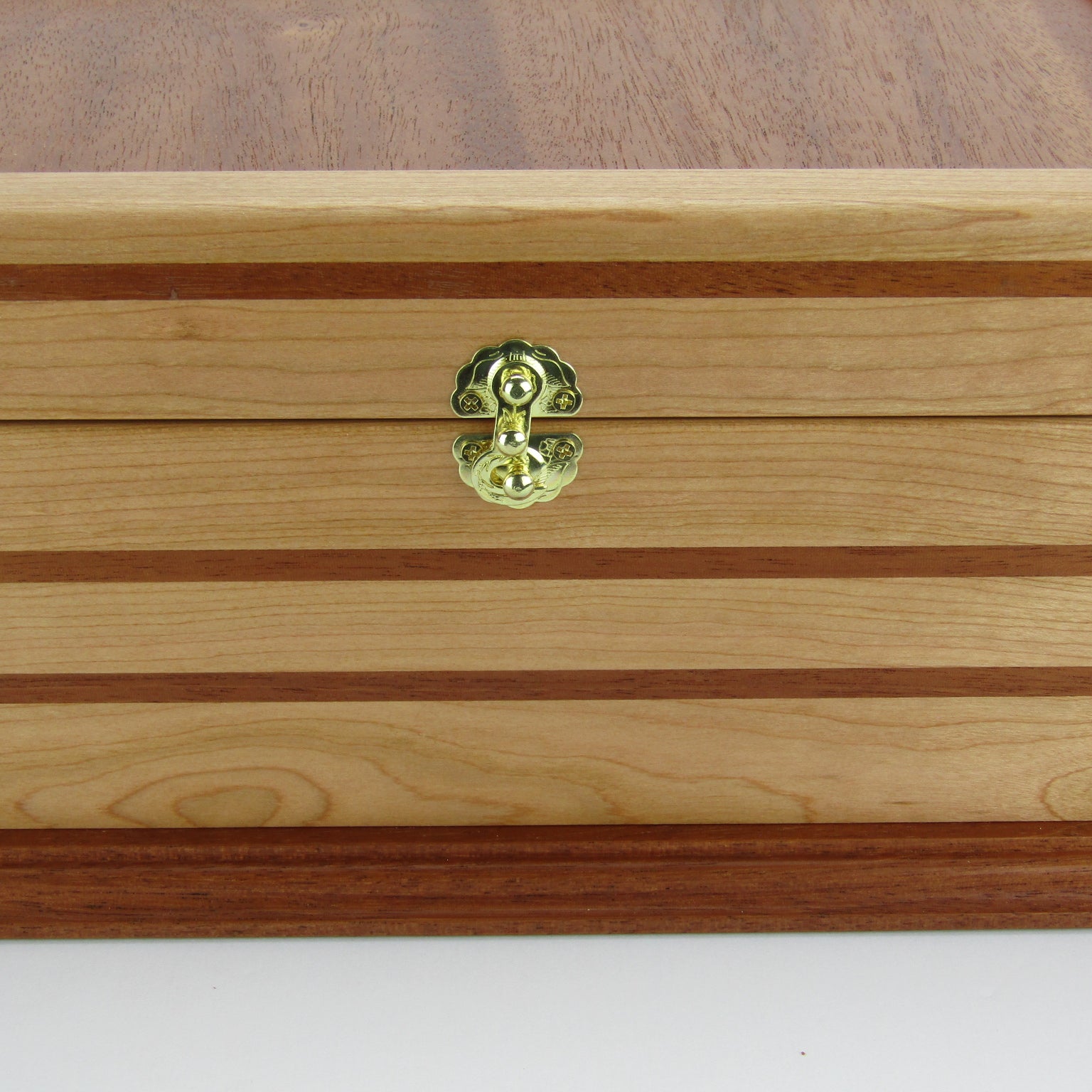 Front view of handmade wood jewelry box crafted from cherry, mahogany, and mahogany veneer by A Finer Cut Woodworking.