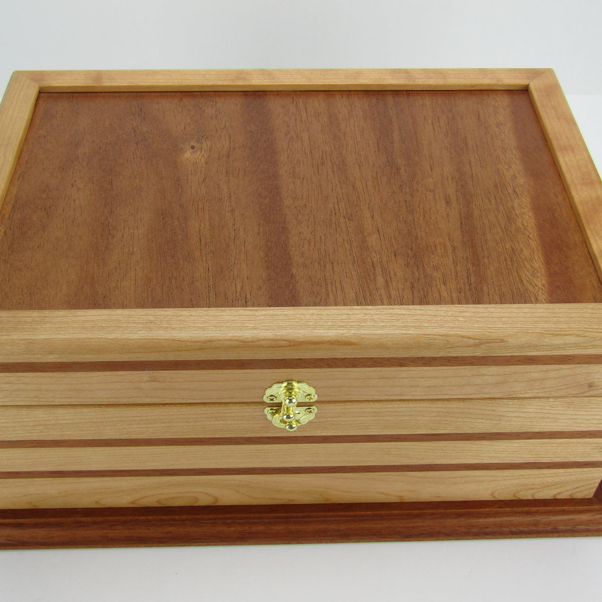 Top view of handmade wood jewelry box crafted from cherry, mahogany, and mahogany veneer by A Finer Cut Woodworking.