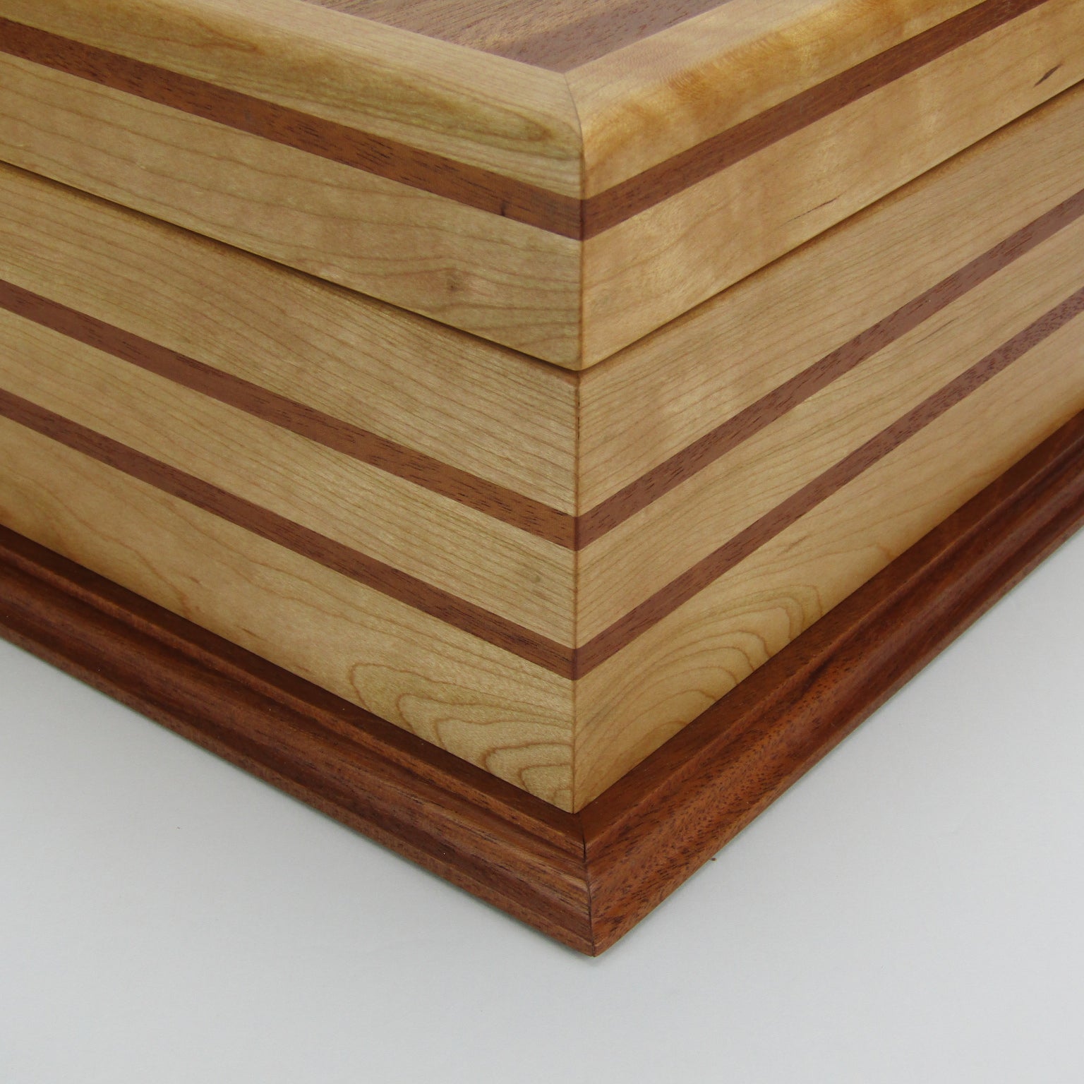 Inlays on handmade wood jewelry box crafted from cherry, mahogany, and mahogany veneer by A Finer Cut Woodworking. 