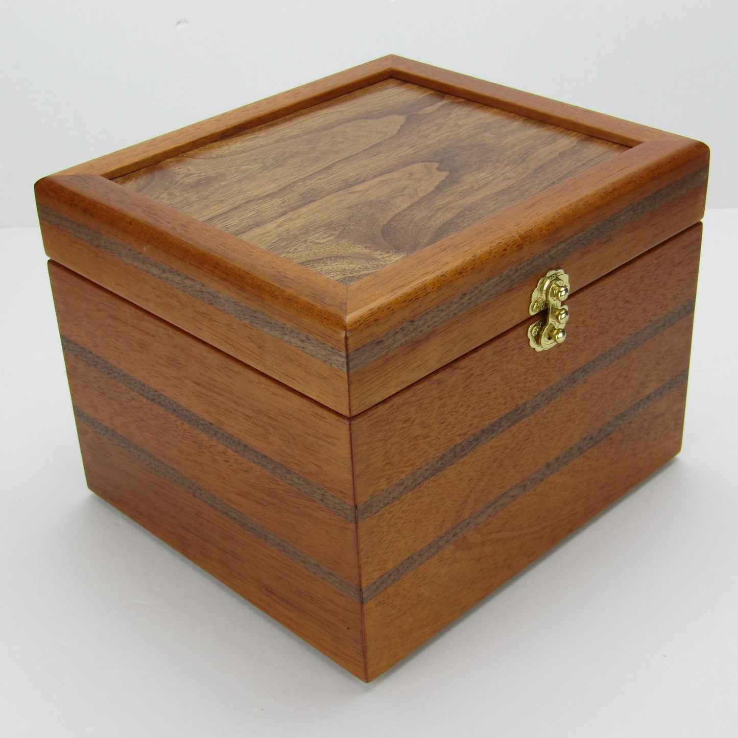 Front corner view of keepsake memory box handmade from mahogany, walnut, and dark finished cherry veneer by A Finer Cut Woodworking.