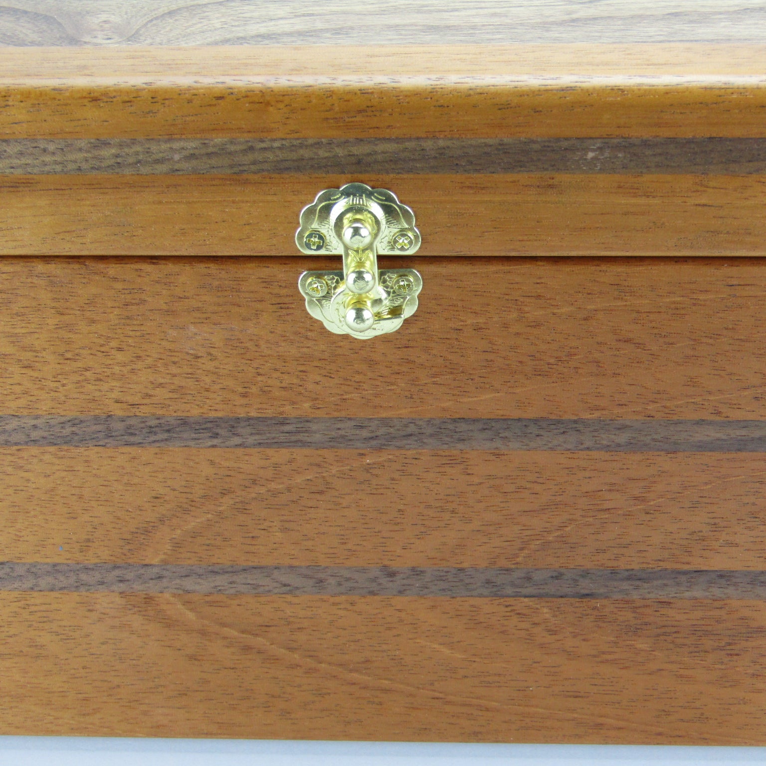 Inlays on keepsake memory box handmade from mahogany, walnut, and dark finished cherry veneer by A Finer Cut Woodworking.