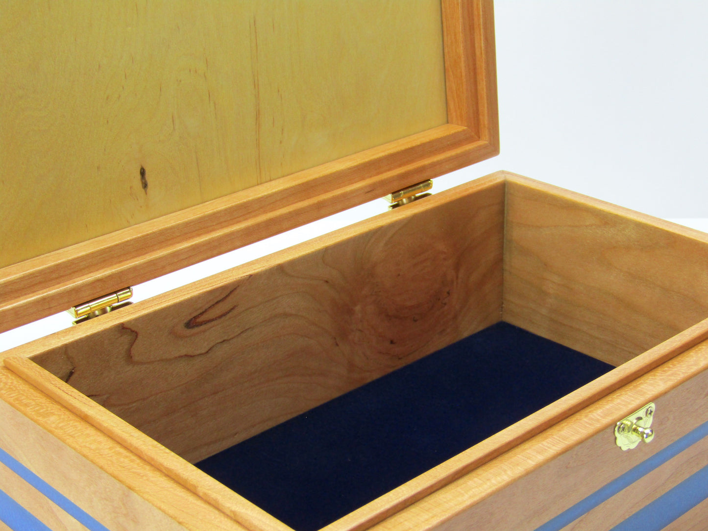 Interior view of keepsake memory box handmade from cherry wood with padauk and epoxy inlays by A Finer Cut Woodwork.