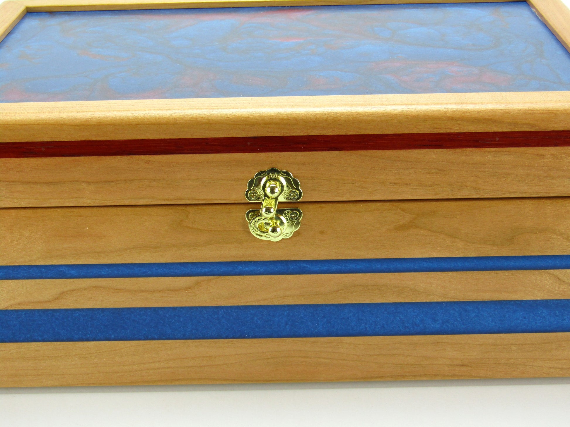 Inlays on keepsake memory box handmade from cherry wood with padauk and epoxy inlays by A Finer Cut Woodwork.