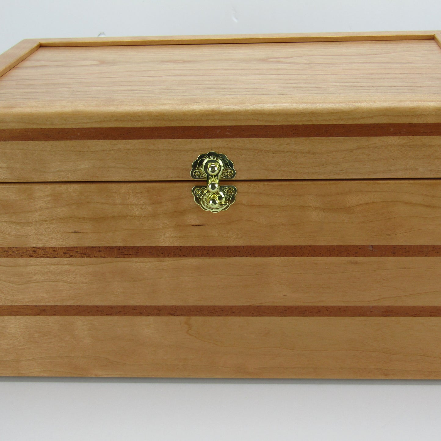 Front view of large keepsake box handmade from cherry, mahogany, and cherry veneer by A Finer Cut Woodworking.