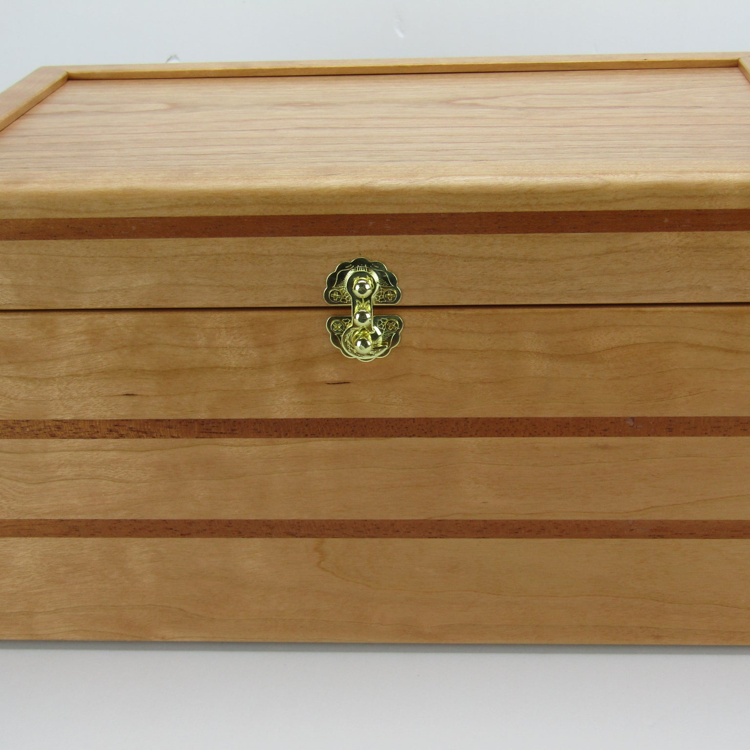 Front view of large keepsake box handmade from cherry, mahogany, and cherry veneer by A Finer Cut Woodworking.