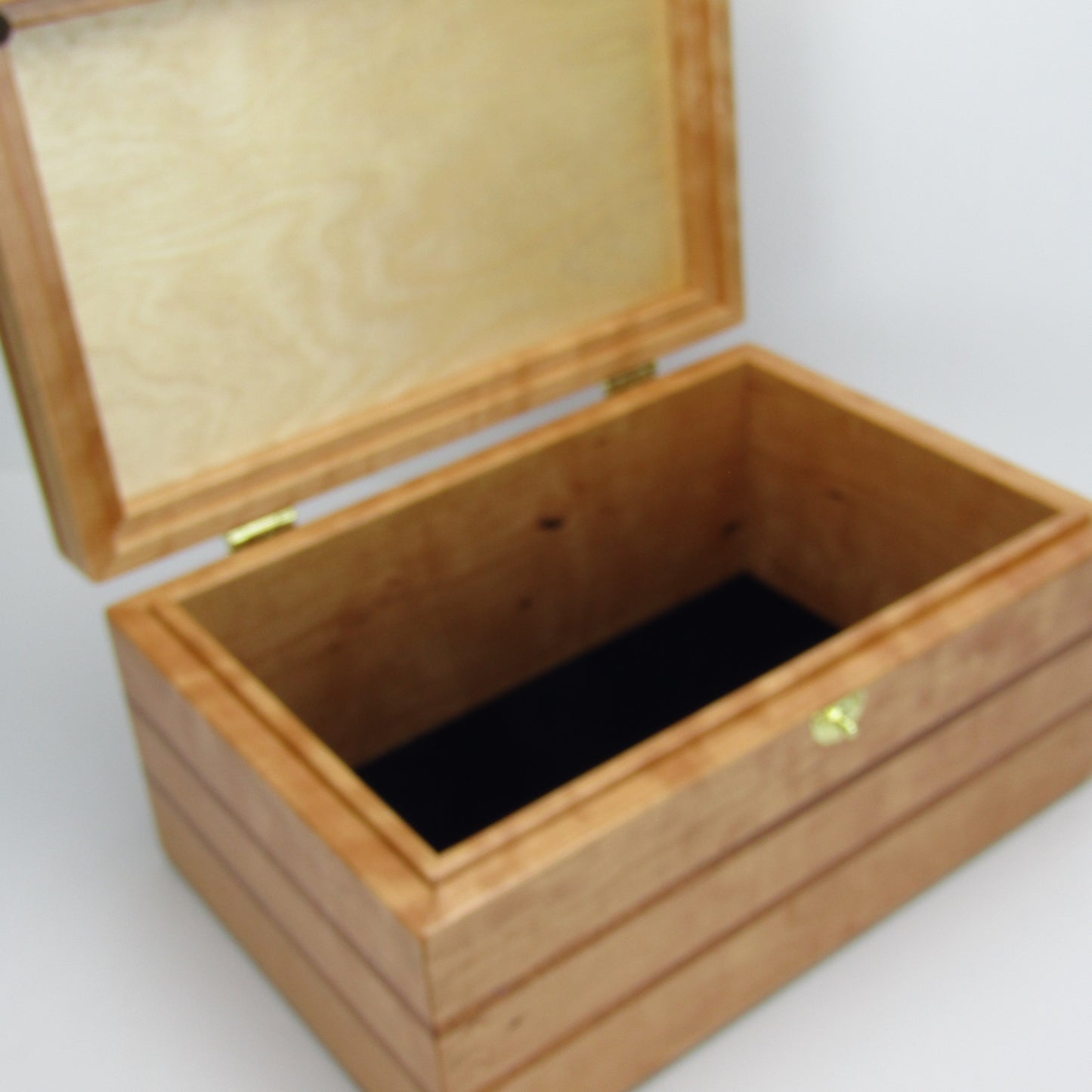 Interior view of large keepsake box handmade from cherry, mahogany, and cherry veneer by A Finer Cut Woodworking.