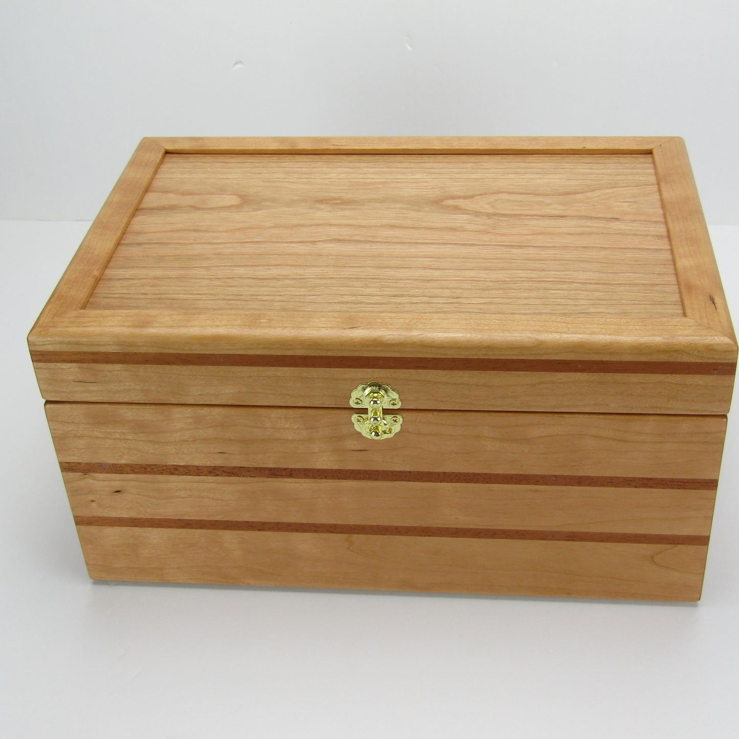Top view of large keepsake box handmade from cherry, mahogany, and cherry veneer by A Finer Cut Woodworking.