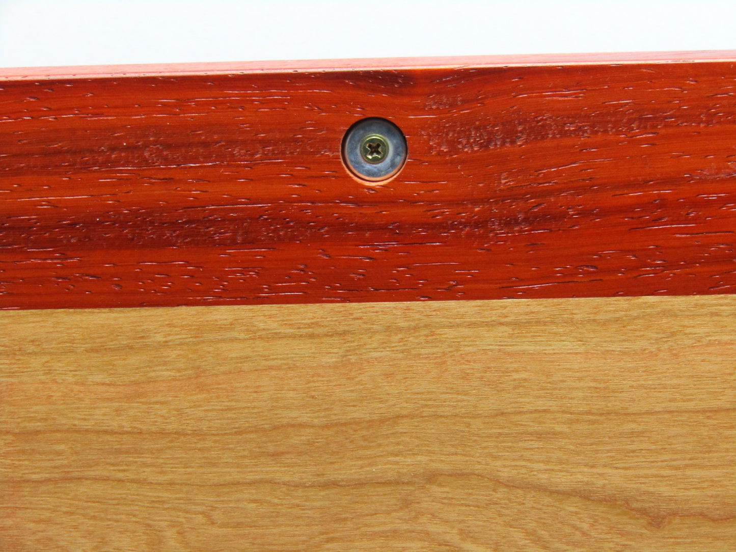Discreet magnetic catch on large keepsake box with raised panels handcrafted from padauk and cherry wood by A Finer Cut.