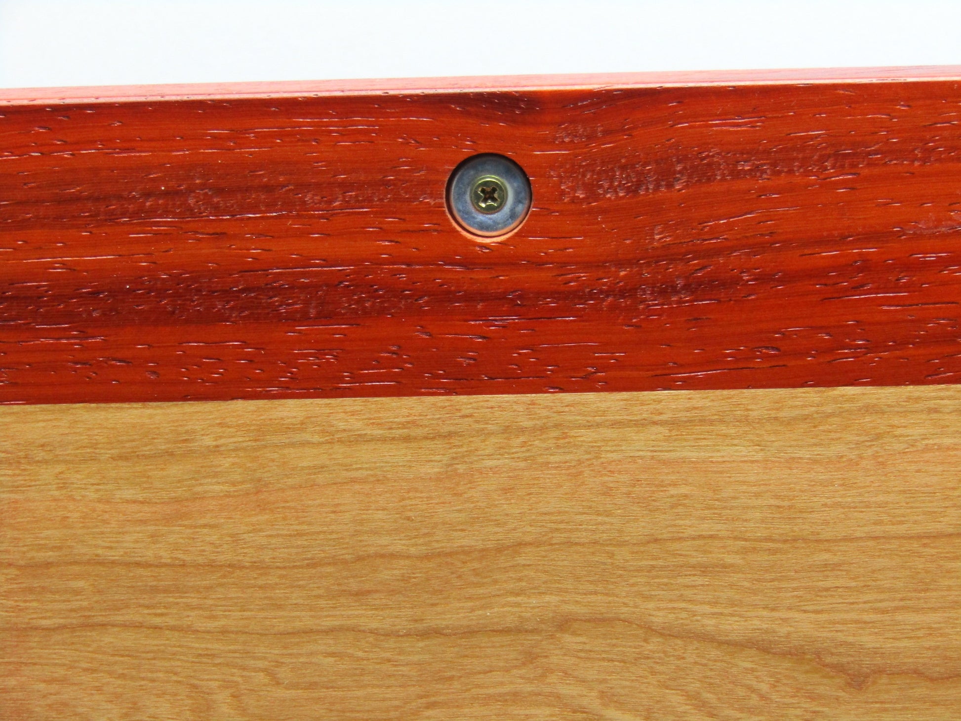 Discreet magnetic catch on large keepsake box with raised panels handcrafted from padauk and cherry wood by A Finer Cut.