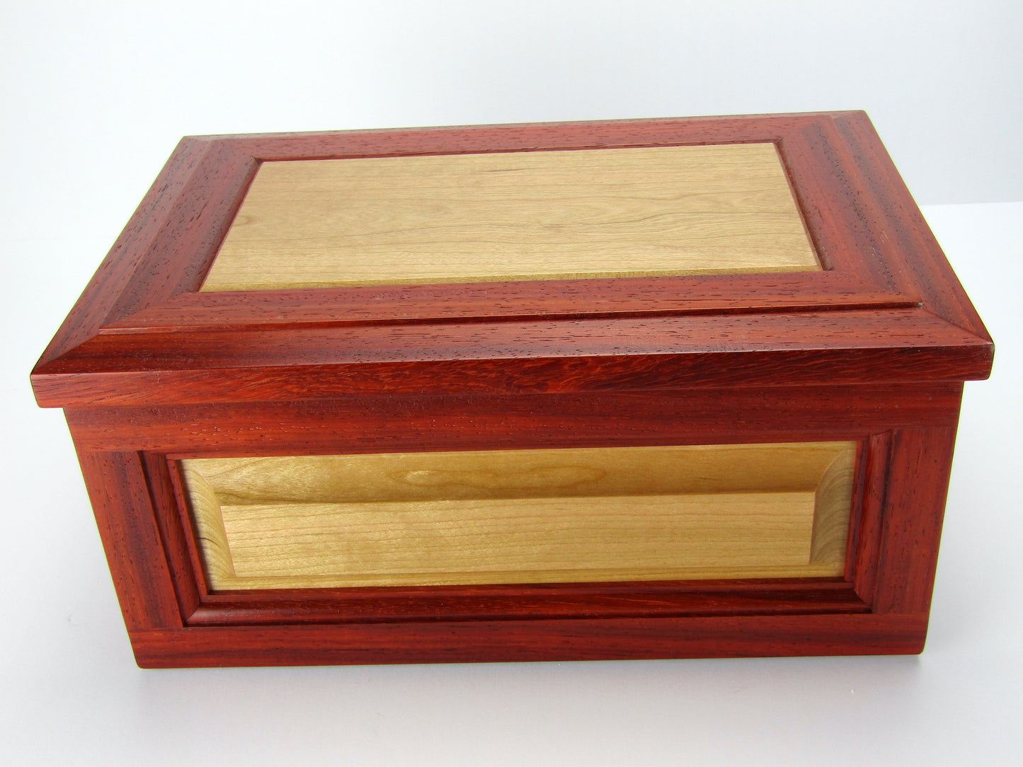 Front view of large keepsake box with raised panels handcrafted from padauk and cherry wood by A Finer Cut.