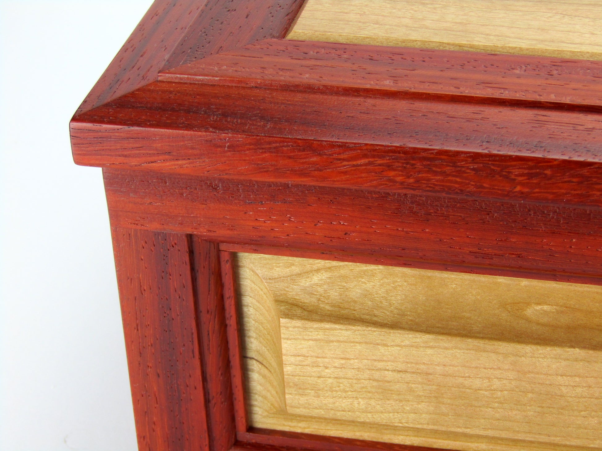 Panel details on large keepsake box with raised panels handcrafted from padauk and cherry wood by A Finer Cut.