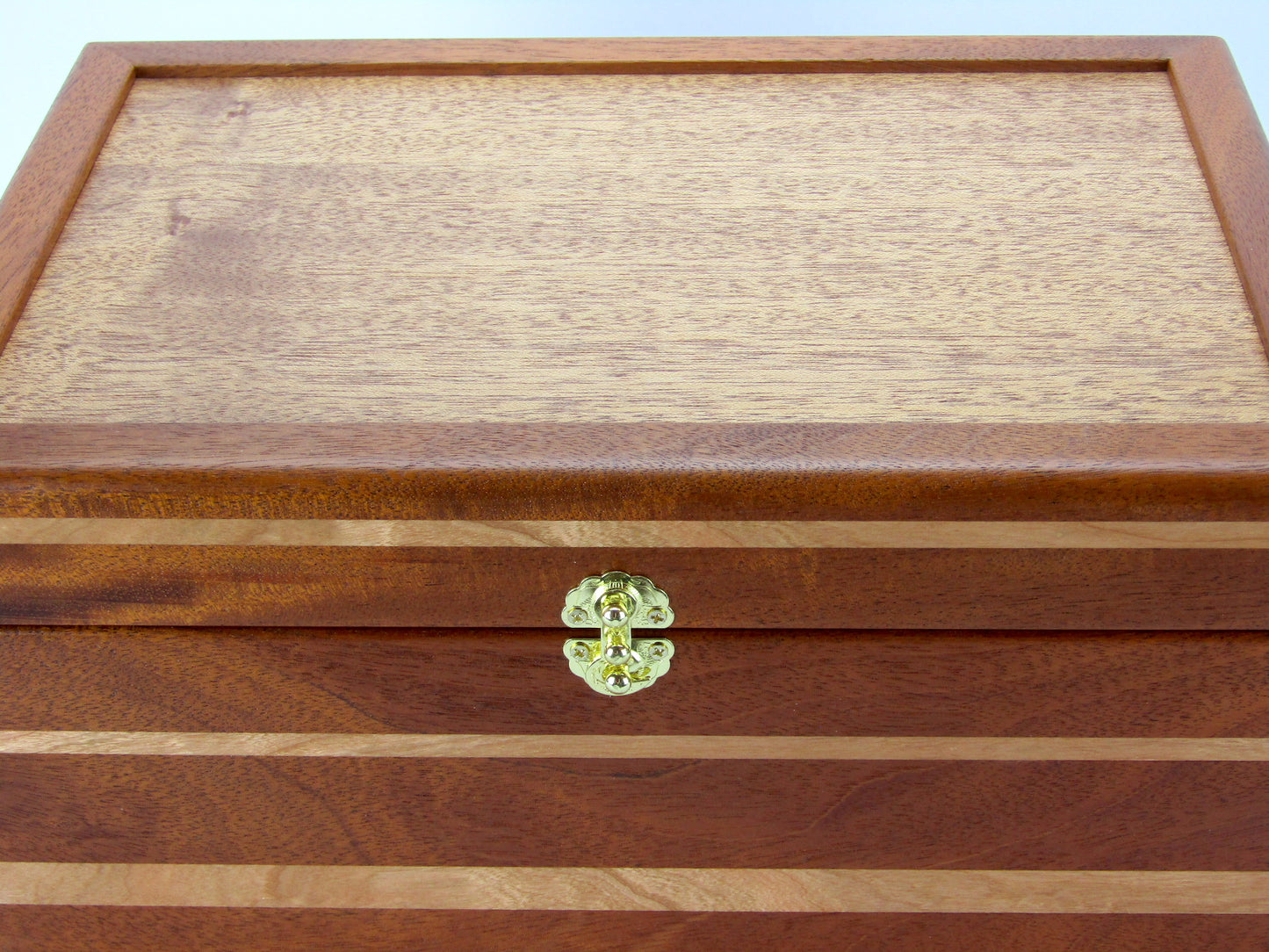 Lid details on large keepsake box handmade from Honduran mahogany and cherry wood by A Finer Cut Woodworking.