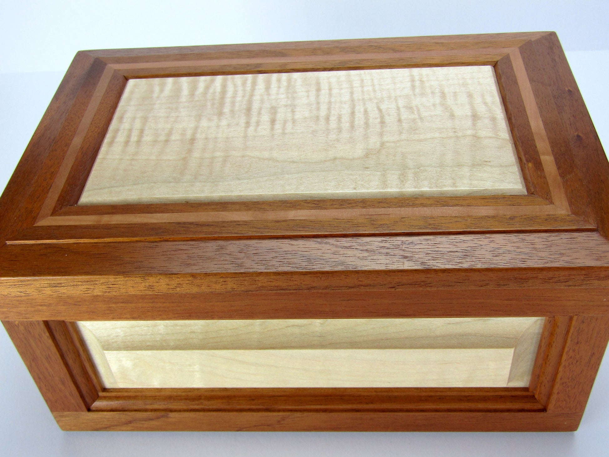 Lid details on large keepsake box handmade from Honduran mahogany, curly maple and pear wood by A Finer Cut Wood.