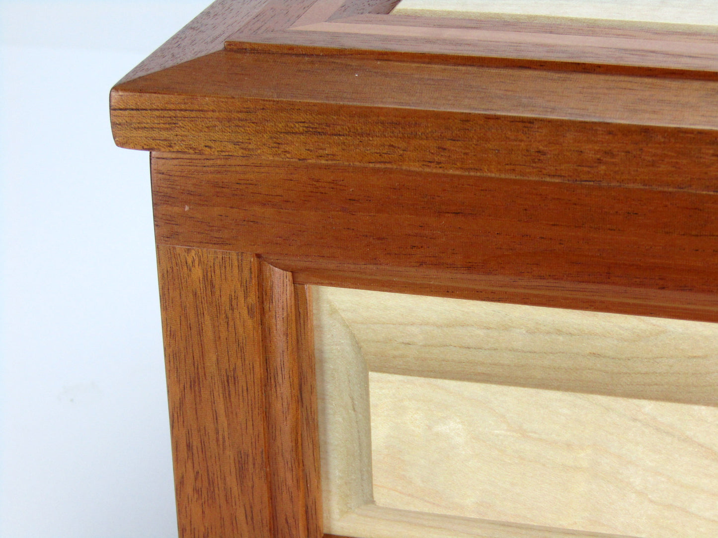 Panel details on large keepsake box handmade from Honduran mahogany, curly maple and pear wood by A Finer Cut Wood.