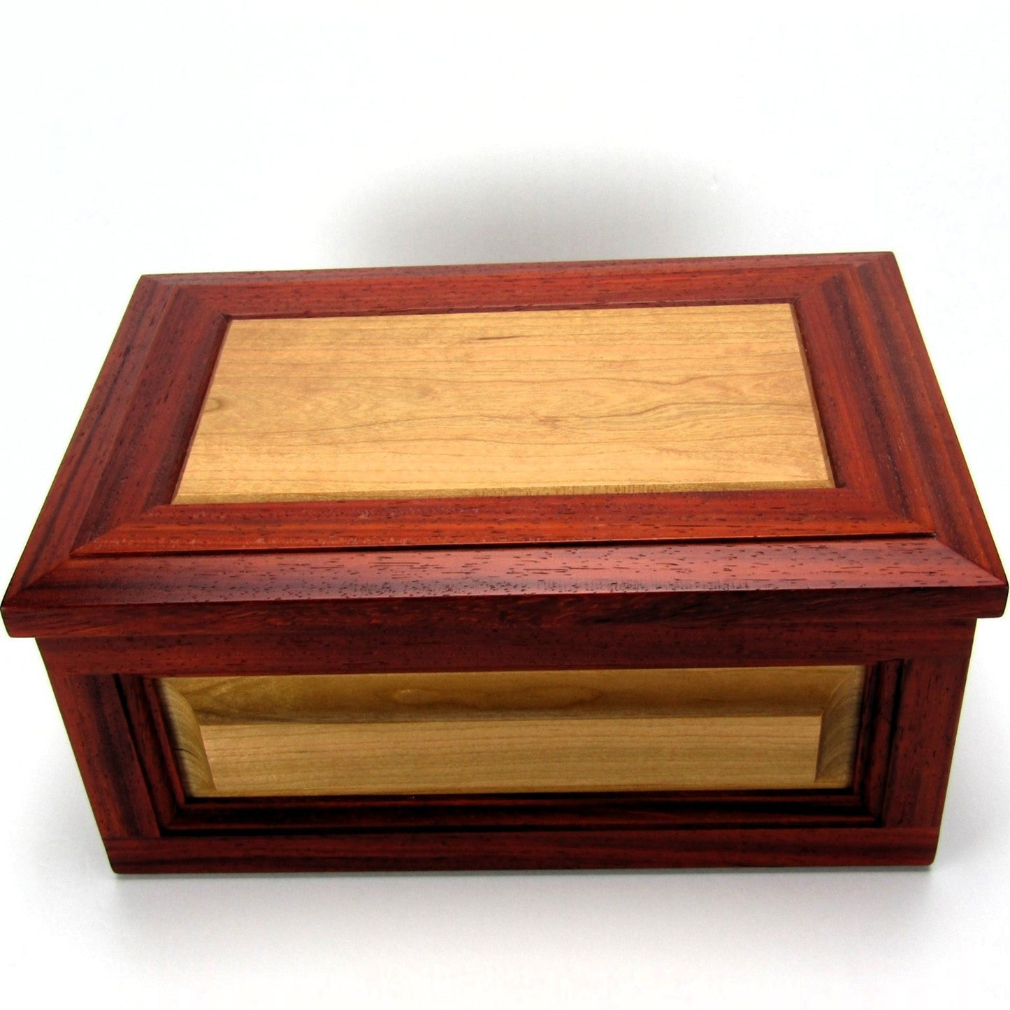 Top view of large keepsake box with raised panels handcrafted from padauk and cherry wood by A Finer Cut.