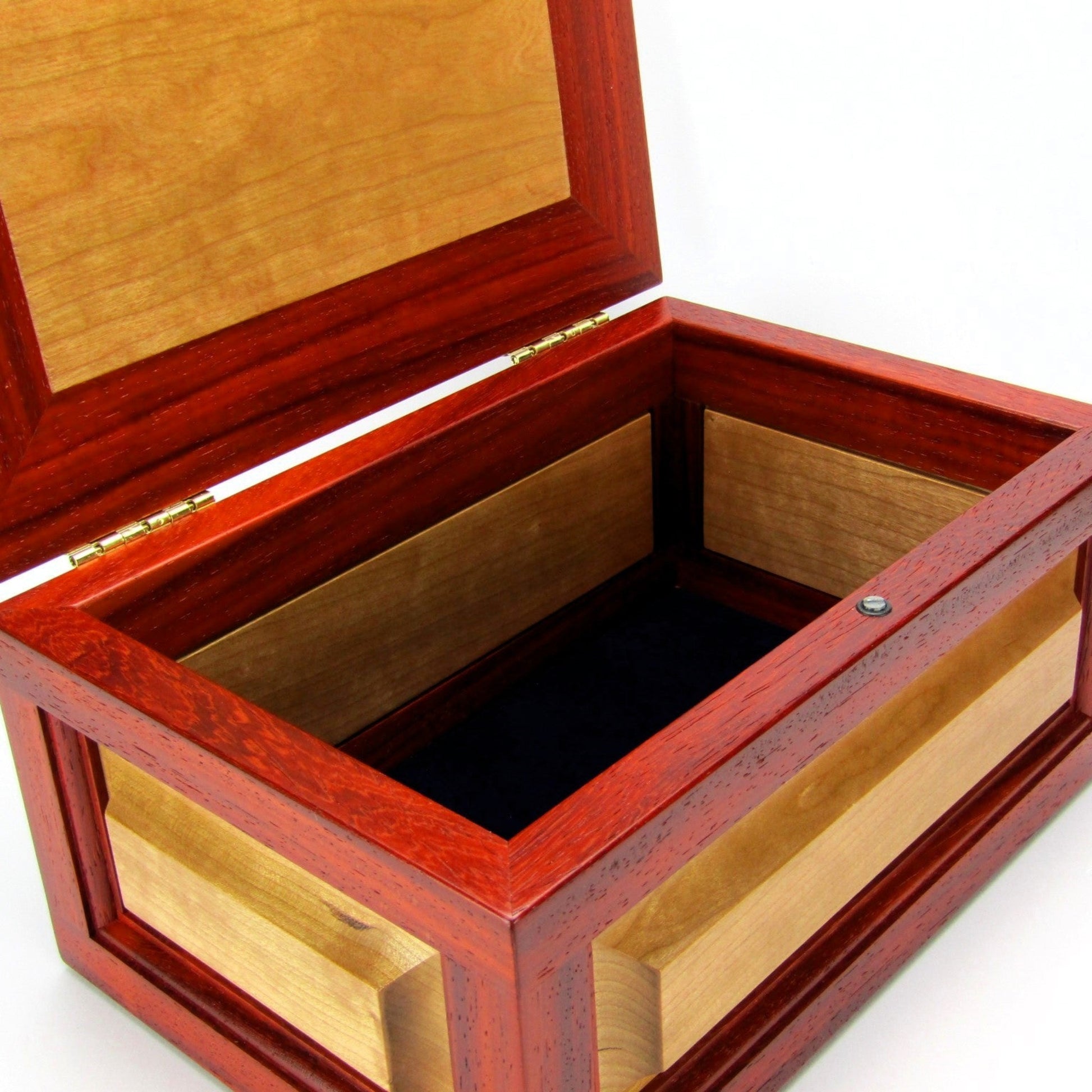 Interior view of large keepsake box with raised panels handcrafted from padauk and cherry wood by A Finer Cut.