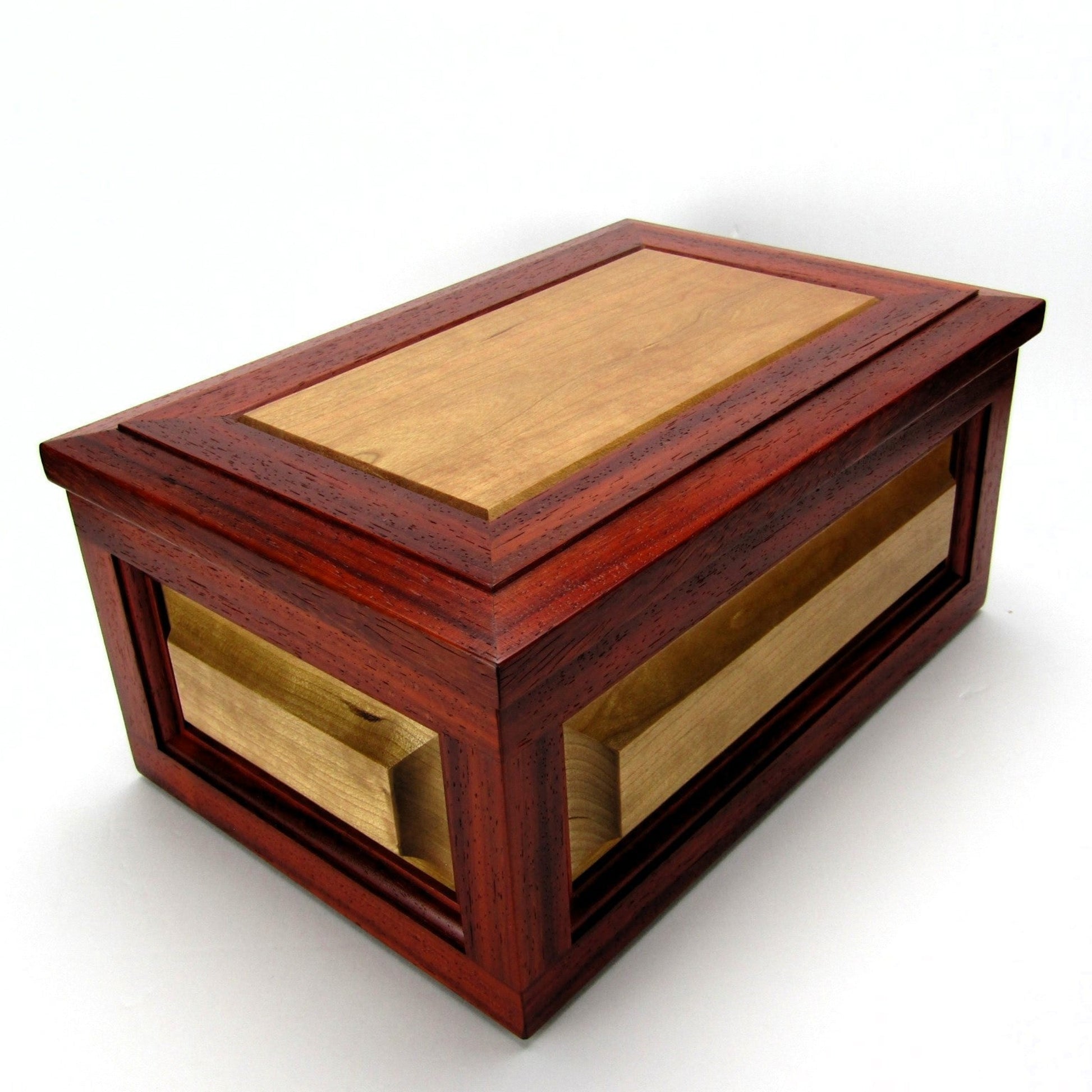 Full view corner of large keepsake box with raised panels handcrafted from padauk and cherry wood by A Finer Cut.
