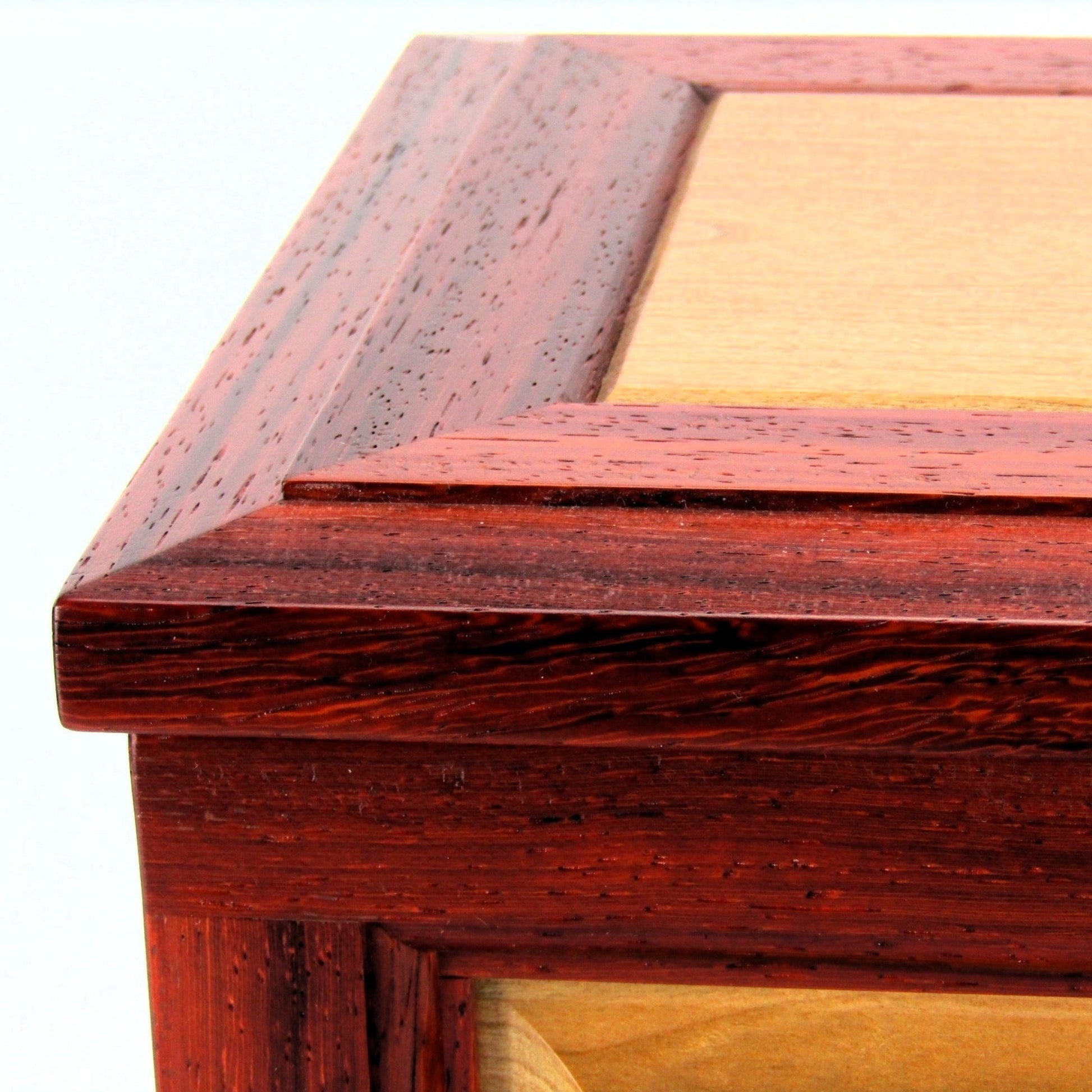 Lid details on large keepsake box with raised panels handcrafted from padauk and cherry wood by A Finer Cut.