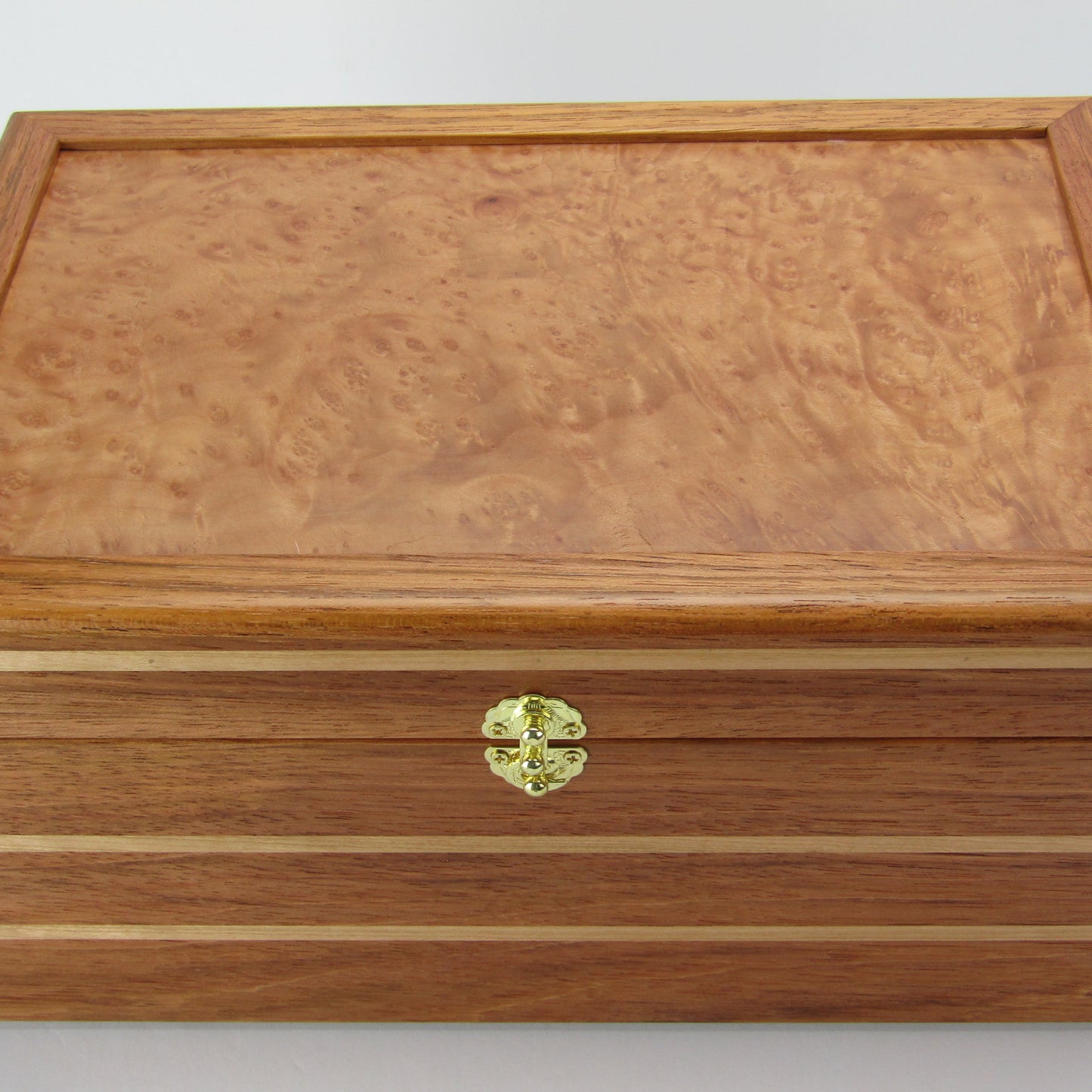 Top view of large memory box handmade from Brazilian cherry and maple burl veneer by A Finer Cut Woodworking.
