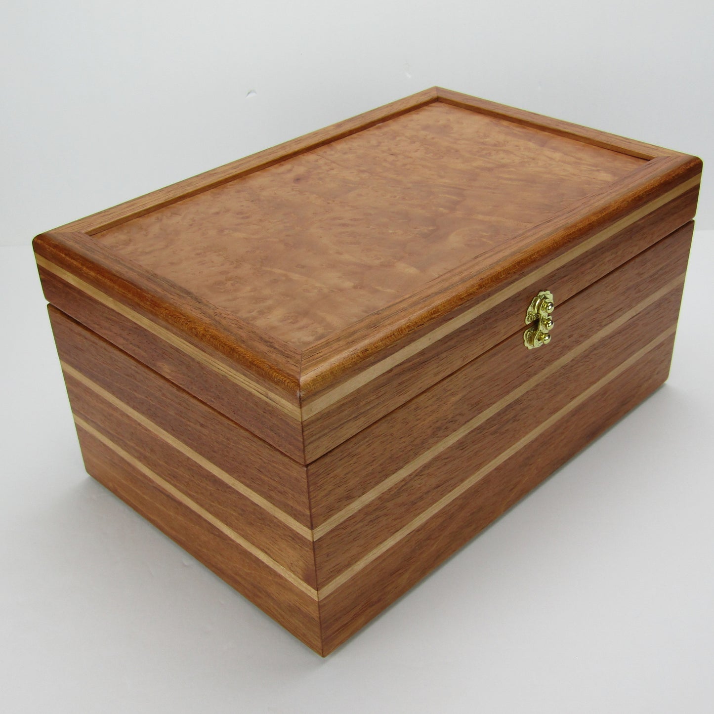 Front corner view of large memory box handmade from Brazilian cherry and maple burl veneer by A Finer Cut Woodworking.