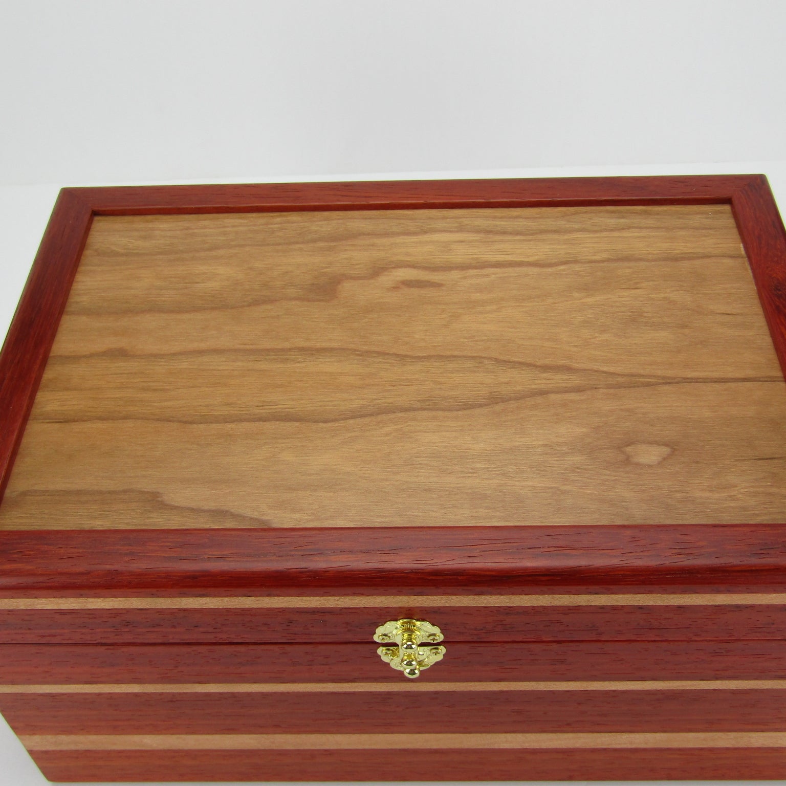 >Top view of large memory box handmade from padauk and cherry wood by A Finer Cut Woodworking.