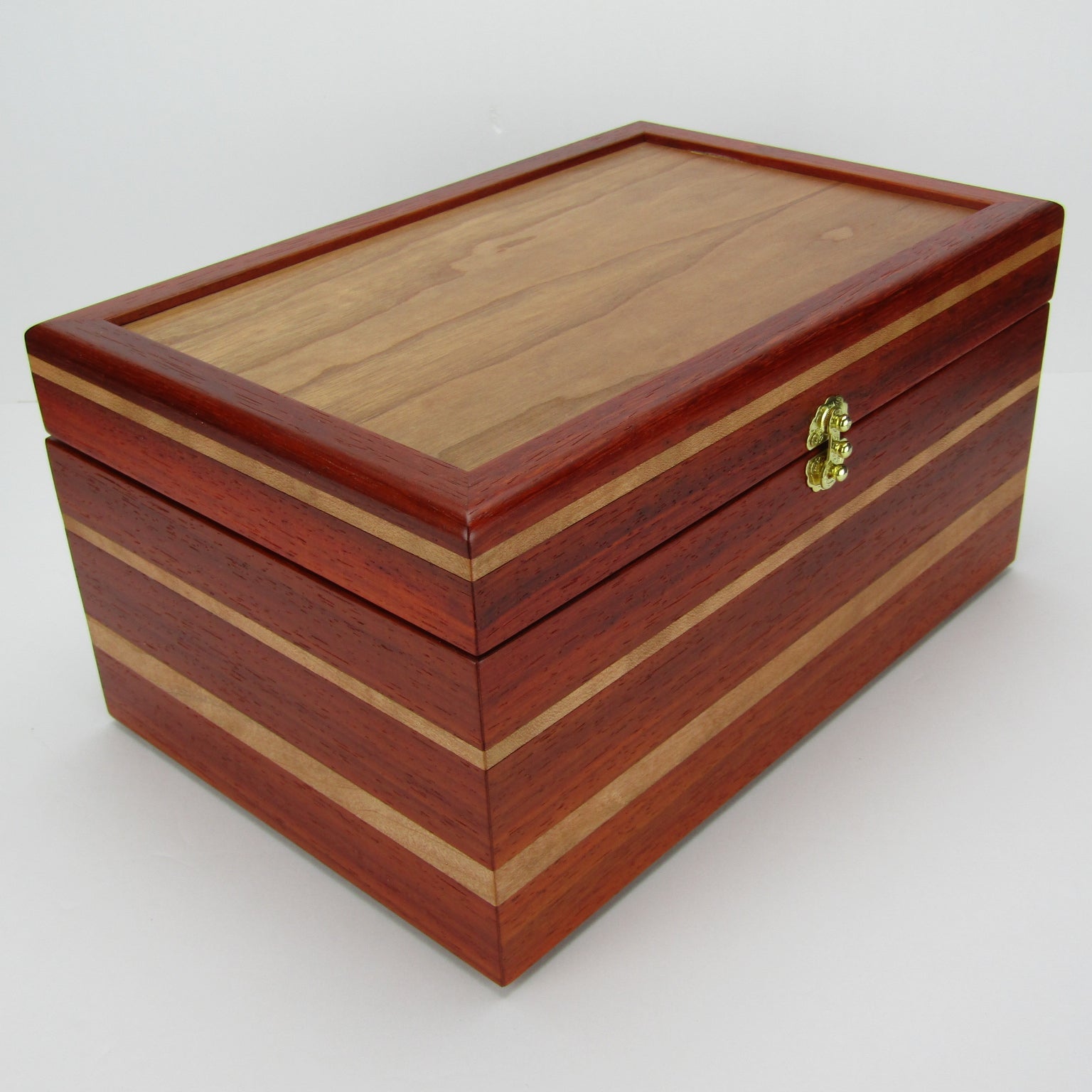 >Front corner view of large memory box handmade from padauk and cherry wood by A Finer Cut Woodworking.