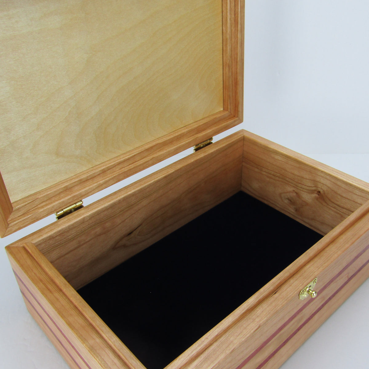 Interior view of unique memorial box handcrafted from domestic cherry, padauk, and dark finished cherry veneer by A Finer Cut Woodworking. 