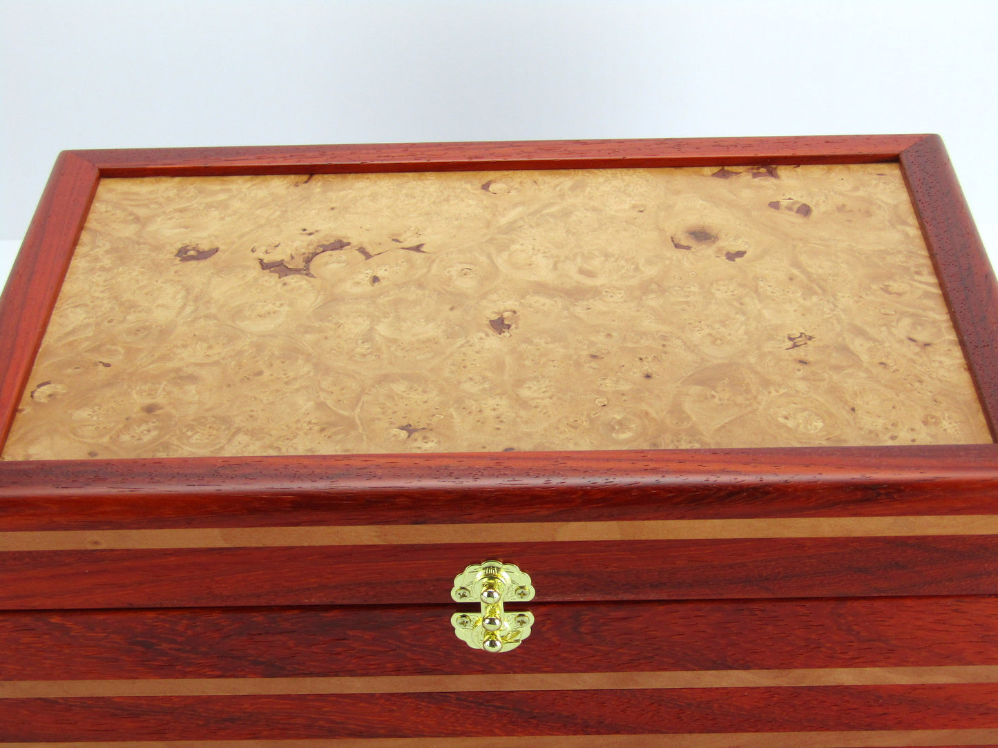 Lid details on unique memorial box handcrafted from red padauk and pear wood by A Finer Cut Woodworking. 