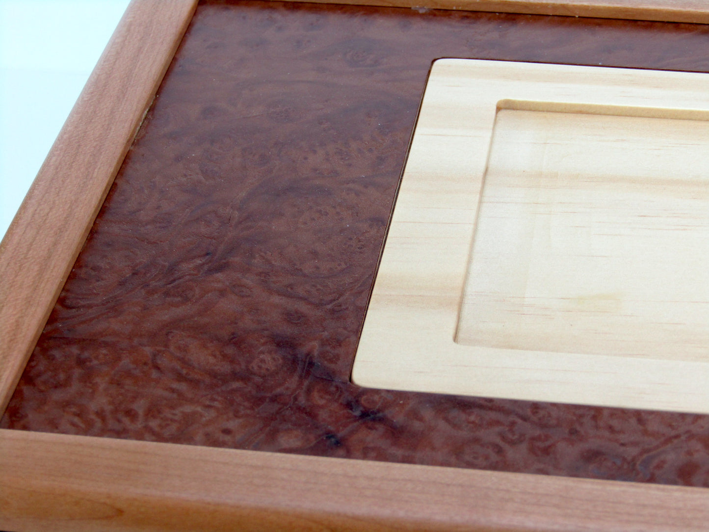 Lid details on memorial box handcrafted from cherry, mahogany and wenge wood by A Finer Cut Woodworking. 