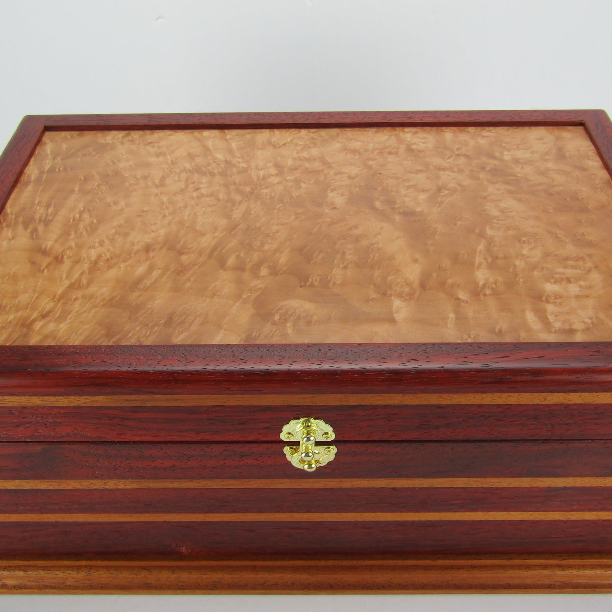Top view of unique memorial keepsake box handmade from padauk, mahogany, and maple burl veneer  by A Finer Cut Woodworking. 